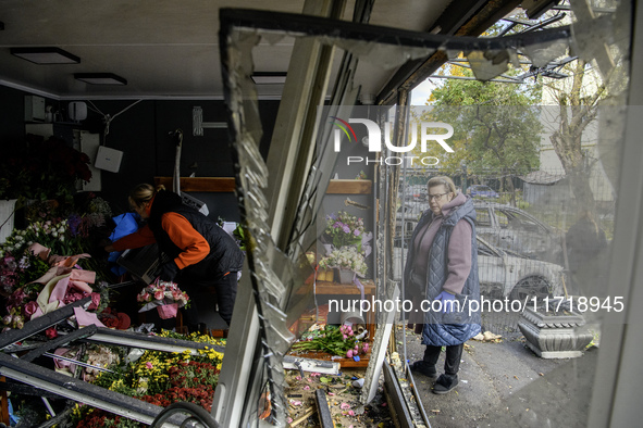 A woman inspects the damage to a flower shop after a Russian drone strike in Kyiv, Ukraine, on October 29, 2024 