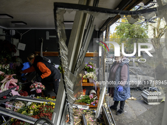 A woman inspects the damage to a flower shop after a Russian drone strike in Kyiv, Ukraine, on October 29, 2024 (