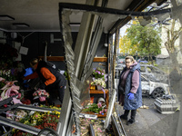 A woman inspects the damage to a flower shop after a Russian drone strike in Kyiv, Ukraine, on October 29, 2024 (