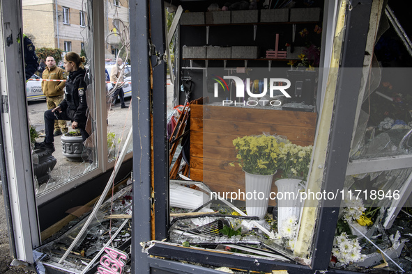 A woman inspects the damage to a flower shop after a Russian drone strike in Kyiv, Ukraine, on October 29, 2024 