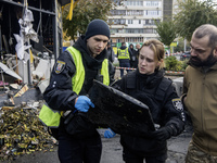 Experts inspect a part of a Russian Shahed at the site of a Russian drone strike near a residential building in Kyiv, Ukraine, on October 29...