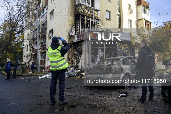 Experts inspect the site of a Russian drone strike near a residential building in Kyiv, Ukraine, on October 29, 2024 