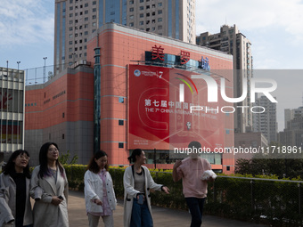 A poster for the 7th China International Import Expo is seen on a building in Shanghai, China, on October 29, 2024. (