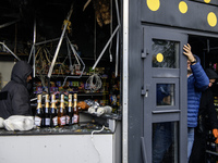 People clean up the damage to a product shop after a Russian drone strike in Kyiv, Ukraine, on October 29, 2024 (