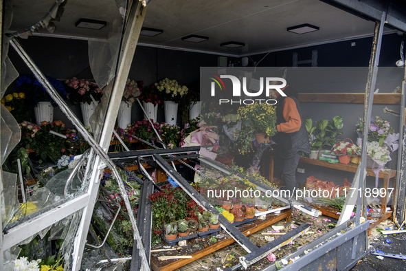 A woman inspects the damage to a flower shop after a Russian drone strike in Kyiv, Ukraine, on October 29, 2024 