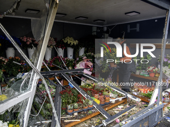 A woman inspects the damage to a flower shop after a Russian drone strike in Kyiv, Ukraine, on October 29, 2024 (