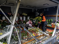 A woman inspects the damage to a flower shop after a Russian drone strike in Kyiv, Ukraine, on October 29, 2024 (