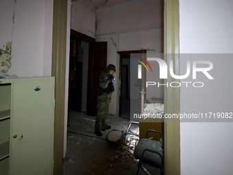 A law enforcer examines the 1930s Derzhprom building damaged by a Russian guided bomb in central Kharkiv, Ukraine, on October 28, 2024. NO U...