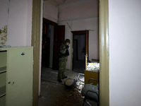 A law enforcer examines the 1930s Derzhprom building damaged by a Russian guided bomb in central Kharkiv, Ukraine, on October 28, 2024. NO U...