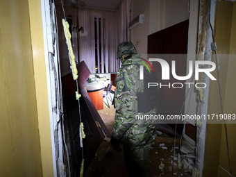 A law enforcer examines the 1930s Derzhprom building damaged by a Russian guided bomb in central Kharkiv, Ukraine, on October 28, 2024. NO U...