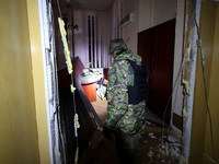 A law enforcer examines the 1930s Derzhprom building damaged by a Russian guided bomb in central Kharkiv, Ukraine, on October 28, 2024. NO U...