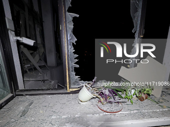 Plants sit on the windowsill of a shattered window in the 1930s Derzhprom building, which is damaged by a Russian guided bomb in central Kha...