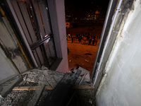 A shattered window frames people in the street outside the 1930s Derzhprom building, which a Russian guided bomb damages in central Kharkiv,...