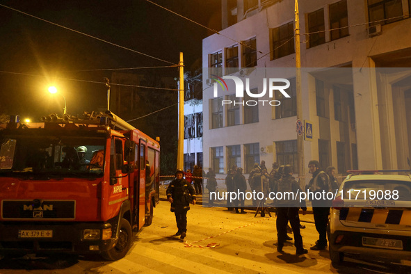 Rescuers and a fire engine are outside the 1930s Derzhprom building damaged by a Russian guided bomb in central Kharkiv, Ukraine, on October...