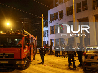 Rescuers and a fire engine are outside the 1930s Derzhprom building damaged by a Russian guided bomb in central Kharkiv, Ukraine, on October...