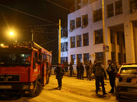 Rescuers and a fire engine are outside the 1930s Derzhprom building damaged by a Russian guided bomb in central Kharkiv, Ukraine, on October...