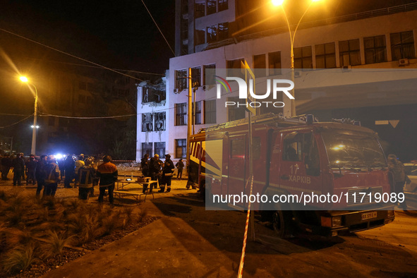 Rescuers and a fire engine are outside the 1930s Derzhprom building damaged by a Russian guided bomb in central Kharkiv, Ukraine, on October...