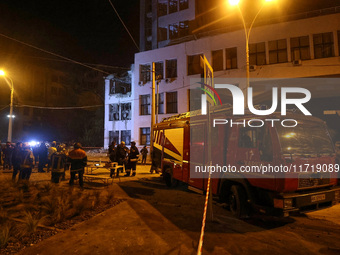 Rescuers and a fire engine are outside the 1930s Derzhprom building damaged by a Russian guided bomb in central Kharkiv, Ukraine, on October...