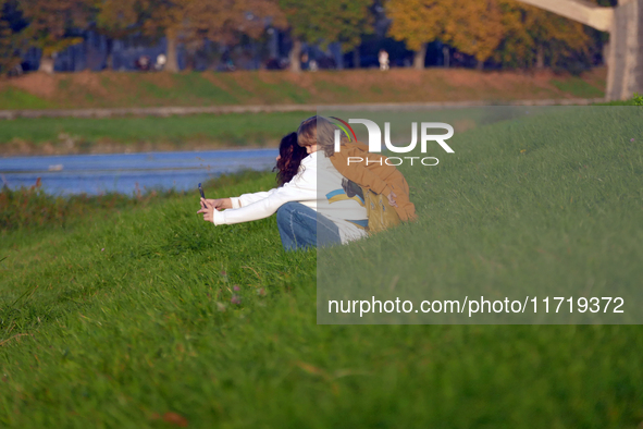 In Uzhhorod, Ukraine, on October 27, 2024, a woman and child take a selfie on the bank of the Uzh River, Uzhhorod, Zakarpattia region, weste...