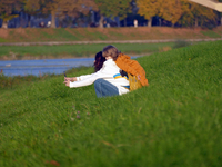 In Uzhhorod, Ukraine, on October 27, 2024, a woman and child take a selfie on the bank of the Uzh River, Uzhhorod, Zakarpattia region, weste...