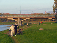 A man and woman push bicycles along a path running by the Uzh River in Uzhhorod, Ukraine, on October 27, 2024. NO USE RUSSIA. NO USE BELARUS...