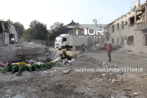 Flowers lie in memory of those killed by the Russian missile attack in the Novokodatskyi district in the evening on Friday, October 25, in D...