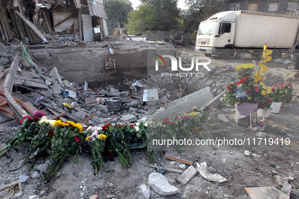 Flowers lie in memory of those killed by the Russian missile attack in the Novokodatskyi district in the evening on Friday, October 25, in D...