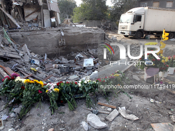 Flowers lie in memory of those killed by the Russian missile attack in the Novokodatskyi district in the evening on Friday, October 25, in D...