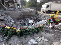 Flowers lie in memory of those killed by the Russian missile attack in the Novokodatskyi district in the evening on Friday, October 25, in D...