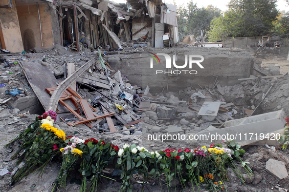 Flowers lie in memory of those killed by the Russian missile attack in the Novokodatskyi district in the evening on Friday, October 25, in D...