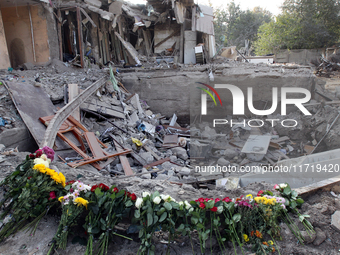 Flowers lie in memory of those killed by the Russian missile attack in the Novokodatskyi district in the evening on Friday, October 25, in D...