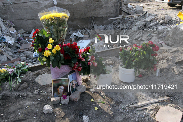 Flowers lie in memory of those killed by the Russian missile attack in the Novokodatskyi district in the evening on Friday, October 25, in D...