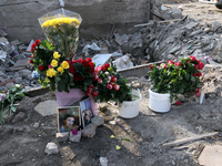 Flowers lie in memory of those killed by the Russian missile attack in the Novokodatskyi district in the evening on Friday, October 25, in D...