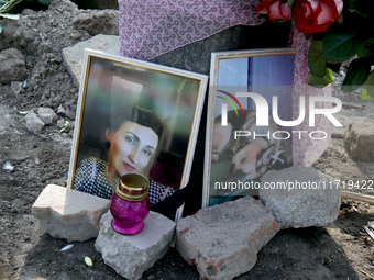 The photographs of a woman and her dog are outside a residential building destroyed by the Russian missile attack in the Novokodatskyi distr...