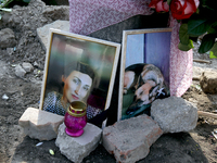 The photographs of a woman and her dog are outside a residential building destroyed by the Russian missile attack in the Novokodatskyi distr...