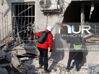 Experts examine the ruins of a residential building after the Russian missile attack in the Novokodatskyi district in Dnipro, Ukraine, on Oc...