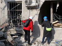 Experts examine the ruins of a residential building after the Russian missile attack in the Novokodatskyi district in Dnipro, Ukraine, on Oc...