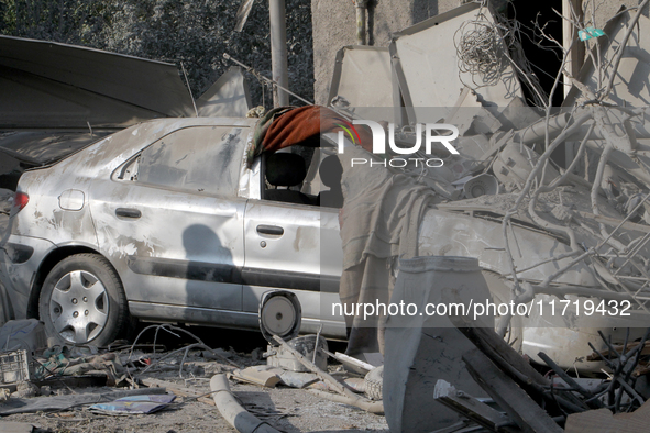 A crushed car is outside a residential building destroyed by the Russian missile attack in the Novokodatskyi district in Dnipro, Ukraine, on...