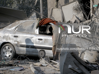 A crushed car is outside a residential building destroyed by the Russian missile attack in the Novokodatskyi district in Dnipro, Ukraine, on...