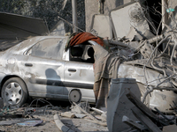 A crushed car is outside a residential building destroyed by the Russian missile attack in the Novokodatskyi district in Dnipro, Ukraine, on...