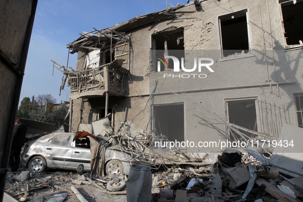 A crushed car is outside a residential building destroyed by the Russian missile attack in the Novokodatskyi district in Dnipro, Ukraine, on...