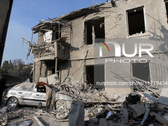 A crushed car is outside a residential building destroyed by the Russian missile attack in the Novokodatskyi district in Dnipro, Ukraine, on...