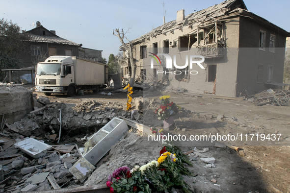 Flowers lie in memory of those killed by the Russian missile attack in the Novokodatskyi district in the evening on Friday, October 25, in D...