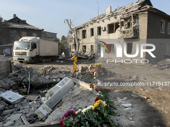 Flowers lie in memory of those killed by the Russian missile attack in the Novokodatskyi district in the evening on Friday, October 25, in D...