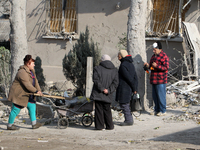 People stand outside a residential building after the Russian missile attack in the Novokodatskyi district in Dnipro, Ukraine, on October 25...