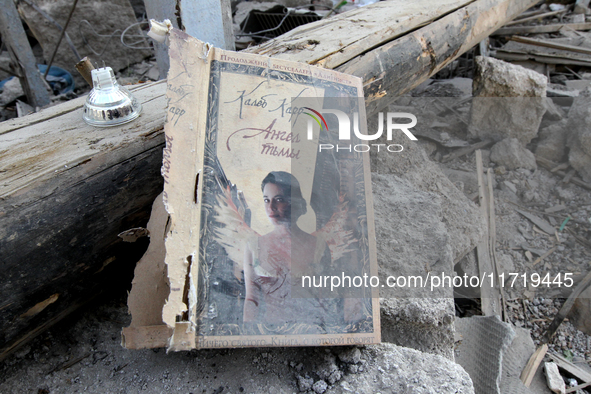 A book cover is among the debris on the ground after the Russian missile attack in the Novokodatskyi district in Dnipro, Ukraine, on October...