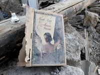 A book cover is among the debris on the ground after the Russian missile attack in the Novokodatskyi district in Dnipro, Ukraine, on October...