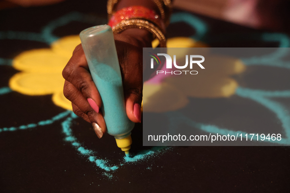 A woman creates a decorative rangoli design in preparation for the festival of Diwali in Toronto, Ontario, Canada, on October 24, 2024. Rang...