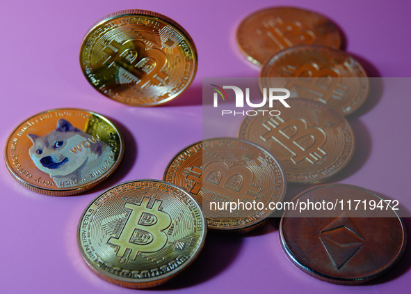 A physical commemorative coin of Bitcoin, Dogecoin, and Ethereum is displayed in Yichang, Hubei province, China, on October 29, 2024. 