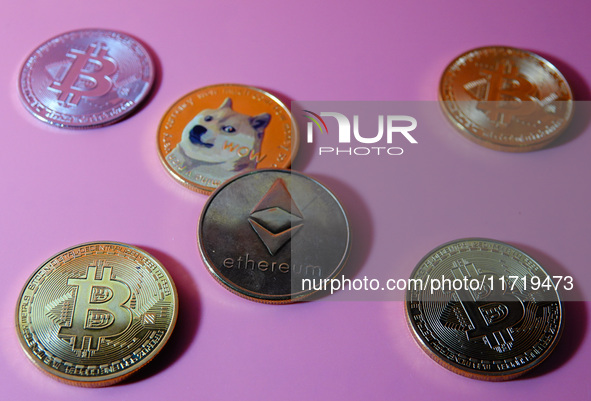 A physical commemorative coin of Bitcoin, Dogecoin, and Ethereum is displayed in Yichang, Hubei province, China, on October 29, 2024. 